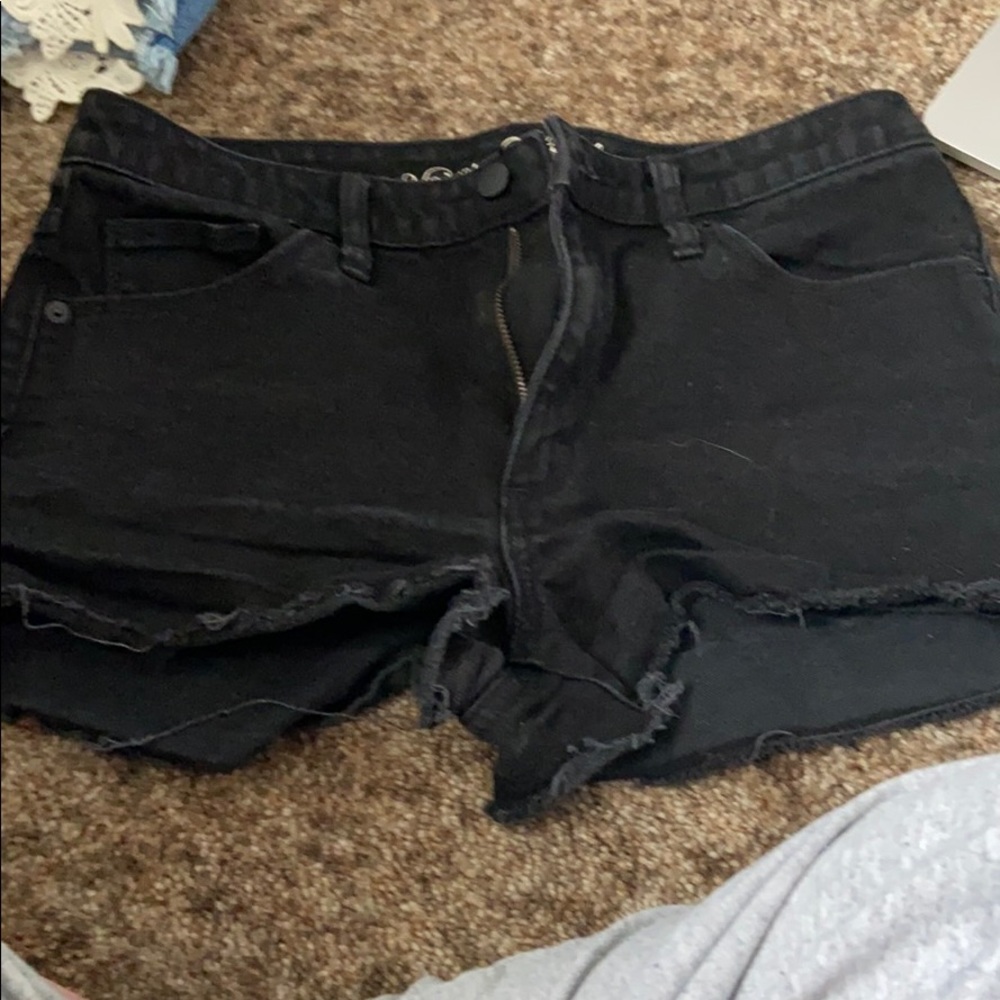 Black shorts with distressed details.